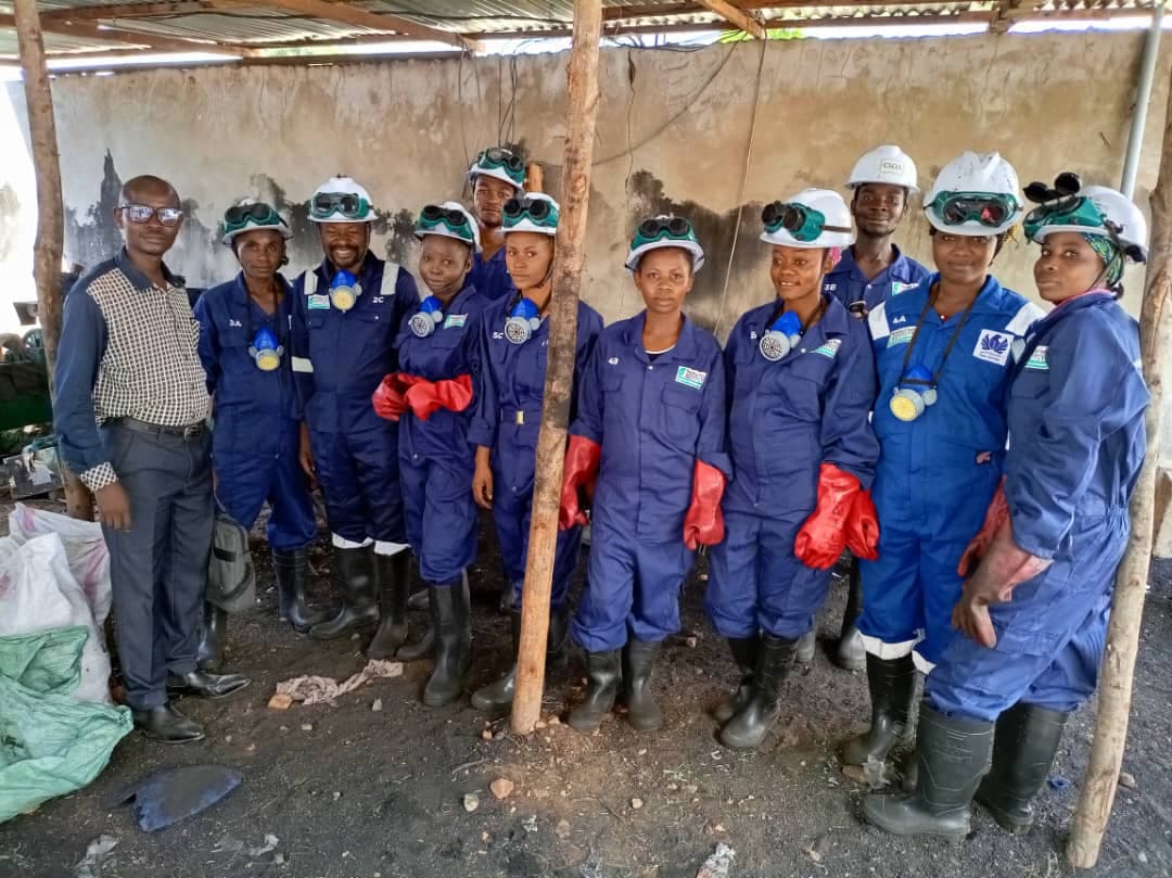 The NFI briquette production team in protective gear at the workshop in Uvira